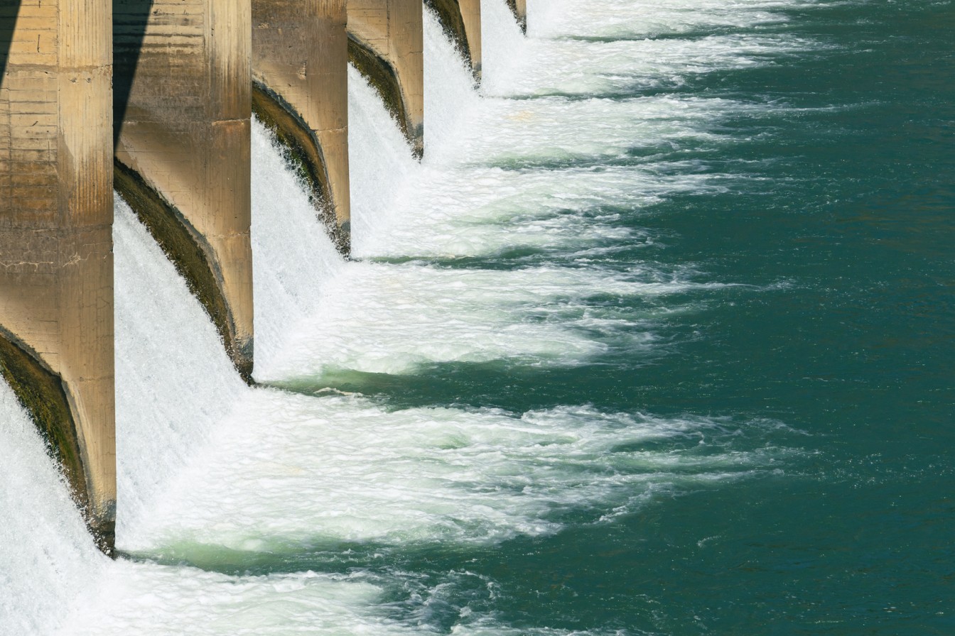 Water bursting forth from pipes in sourcing hydroelectric energy 